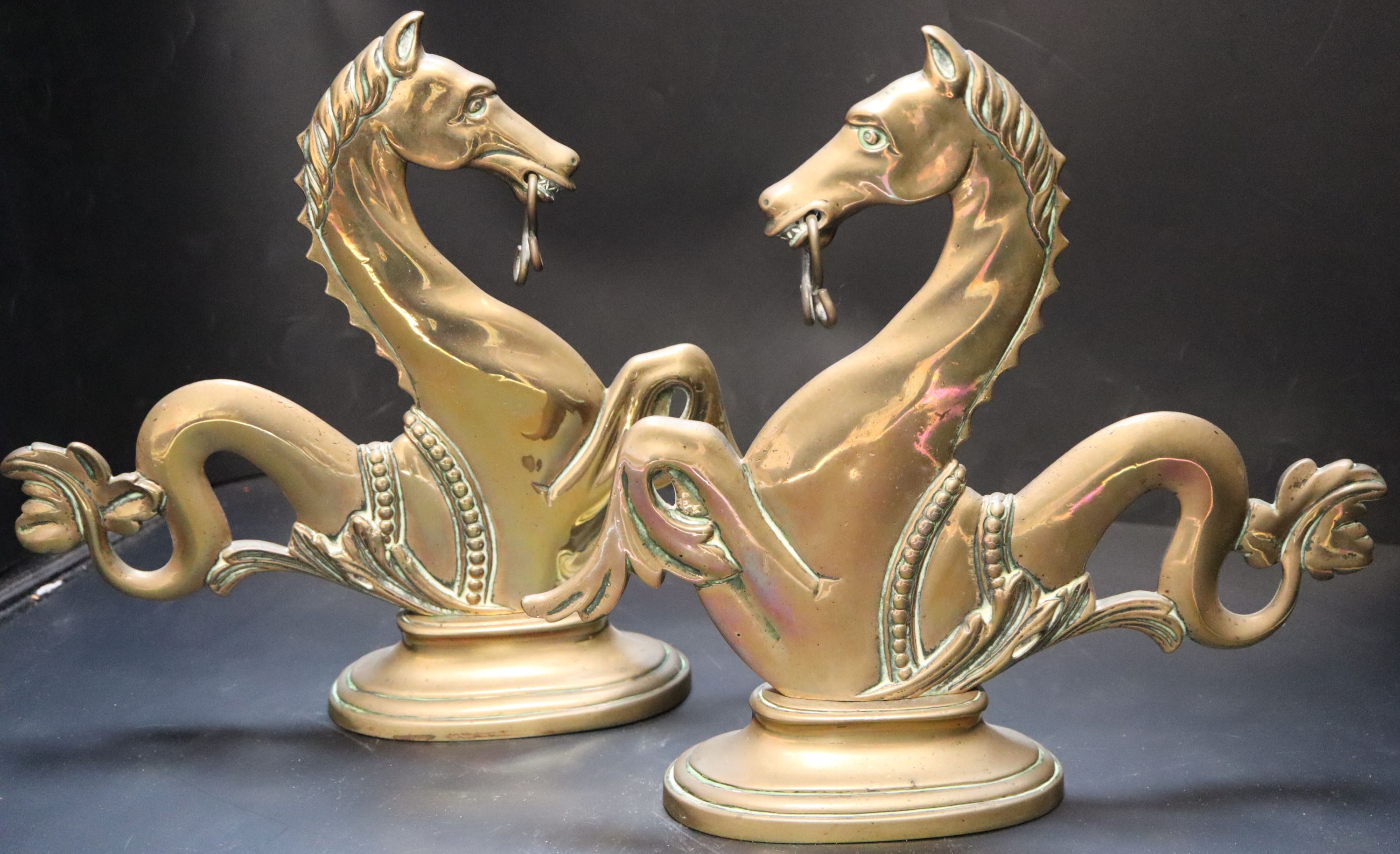 A pair of Venetian brass seahorse gondola finials, height 31cm